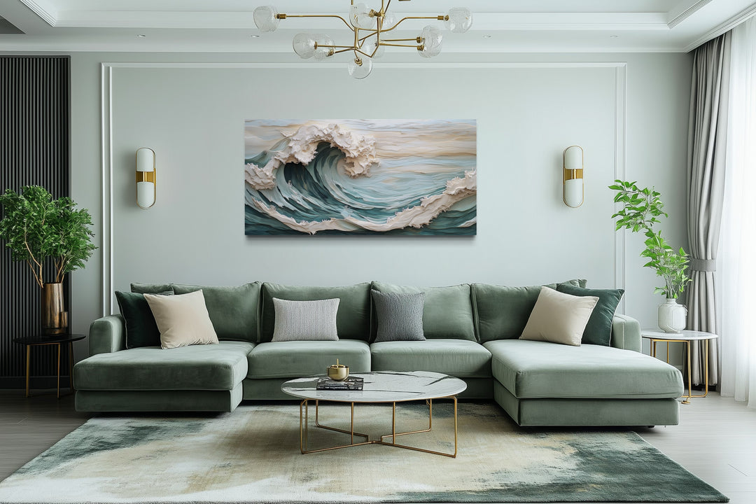 Abstract 3D effect teal ocean wave framed canvas wall art hanging above a green sectional sofa.