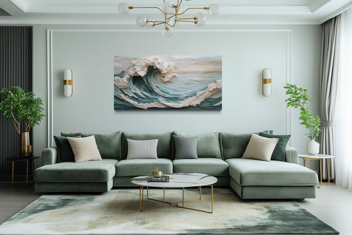 Abstract 3D effect teal ocean wave framed canvas wall art hanging above a green sectional sofa.
