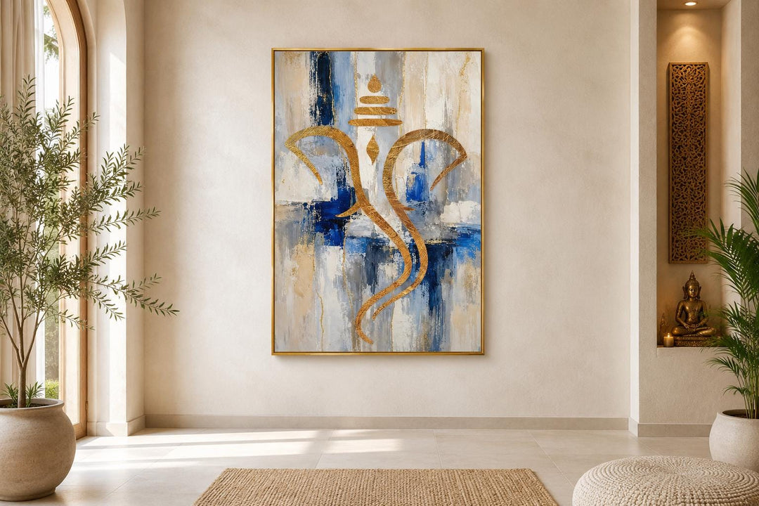 Abstract gold Ganesha silhouette on a textured blue, white, and gold background in a gold frame.