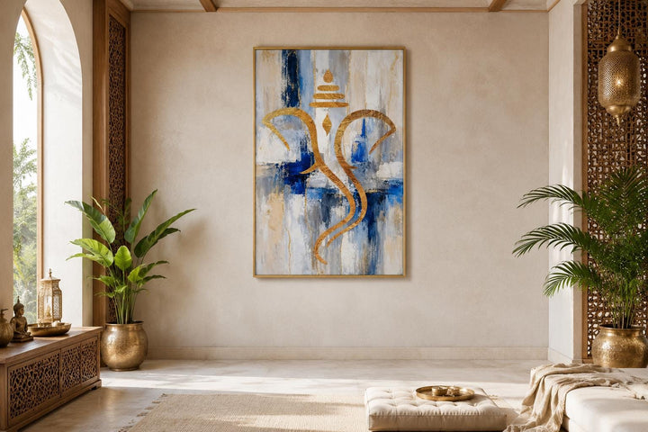 Abstract gold Ganesha silhouette wall art on a textured blue, white, and gold background.
