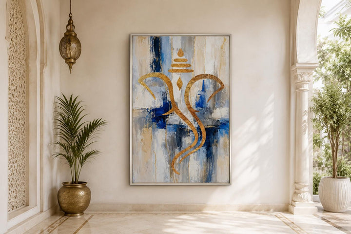 Abstract gold Ganesha silhouette on a textured blue, white, and gold background in a silver frame.