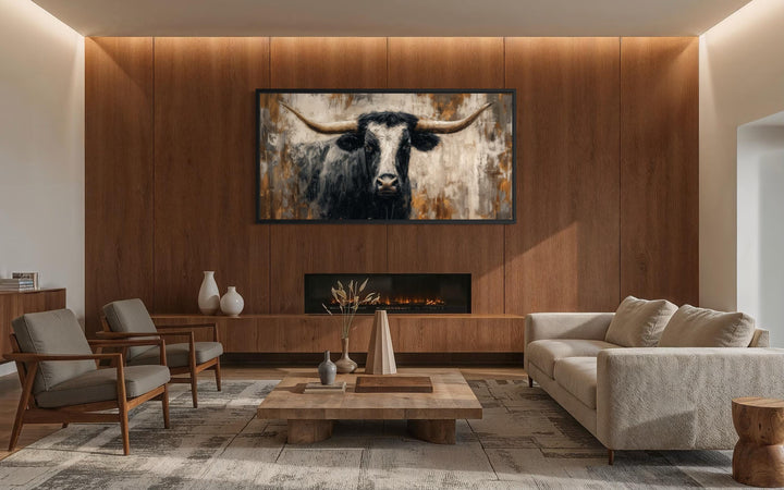 Abstract longhorn bull canvas wall art in a modern industrial living room above a fireplace.