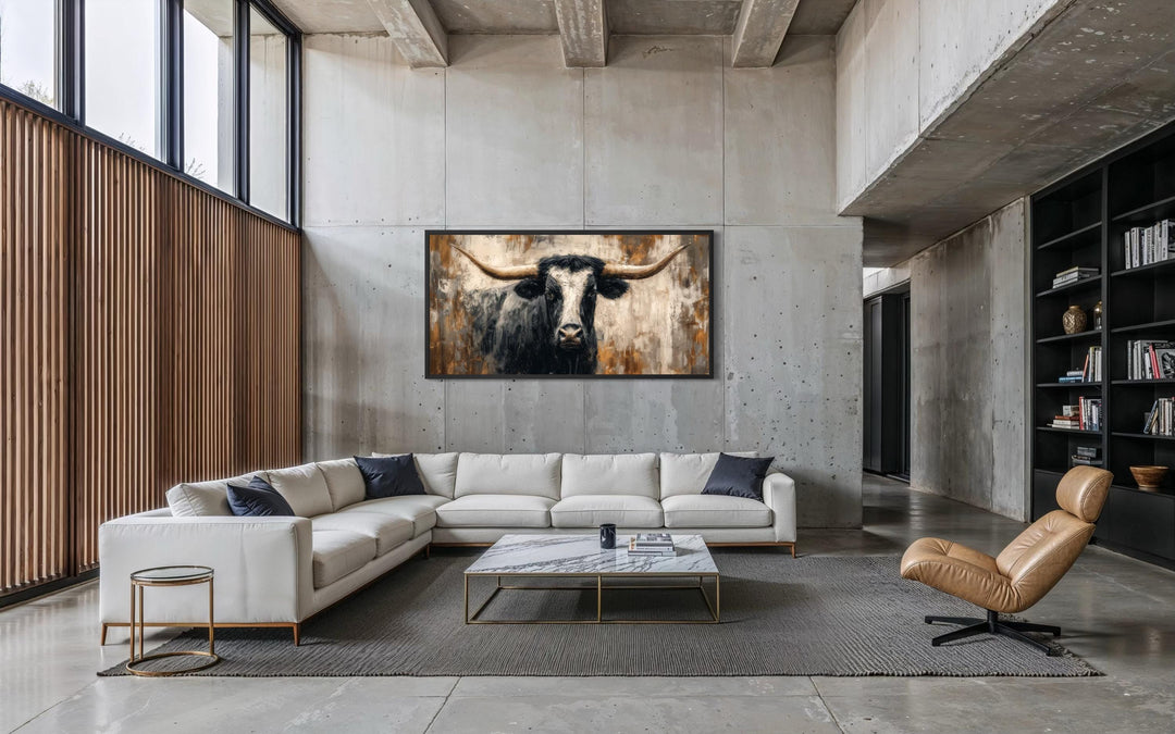 Abstract longhorn bull canvas wall art in a modern industrial living room setting.