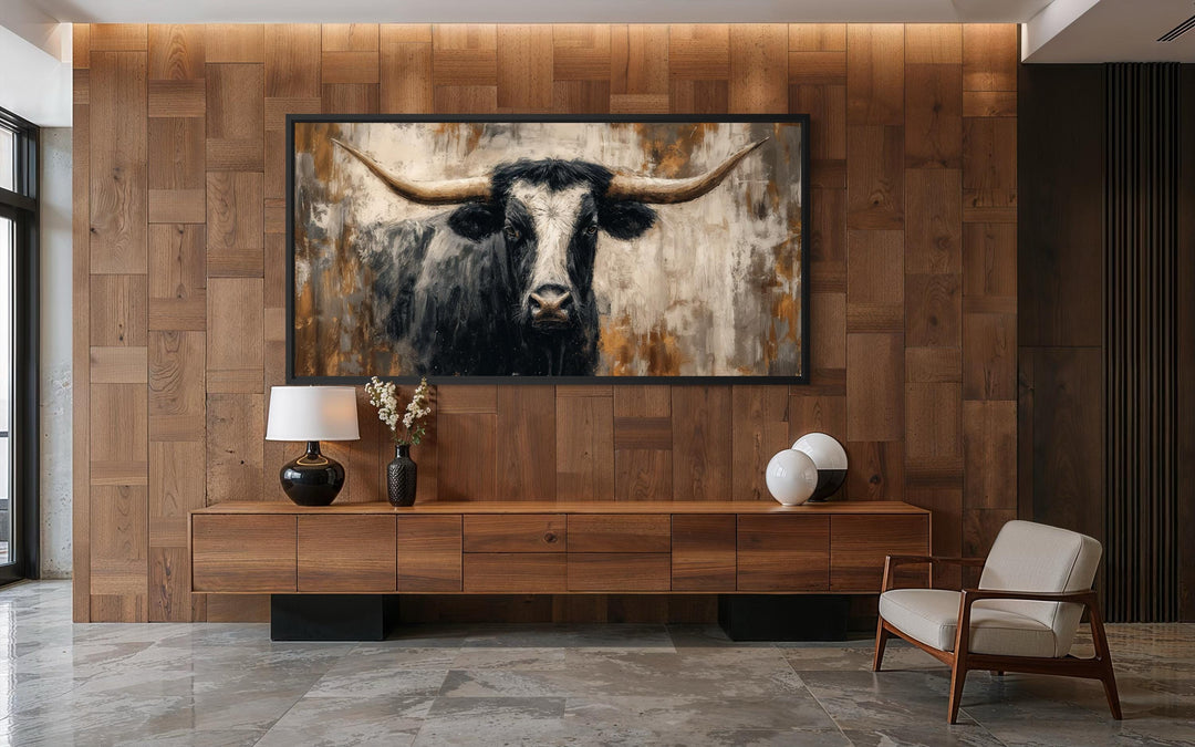 Abstract Longhorn Bull canvas wall art in a modern industrial office with wood paneled walls.