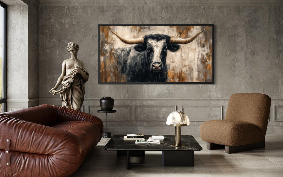 Abstract longhorn bull canvas wall art in a modern industrial living room with a brown sofa.
