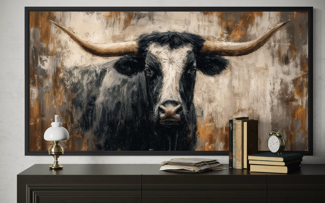 Abstract Longhorn Bull canvas wall art in a modern industrial style above a dark wood dresser.