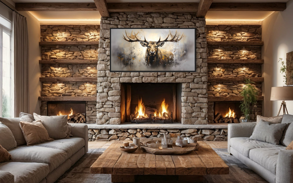 Extra large framed abstract moose canvas print centered above a stone fireplace in a rustic cabin.