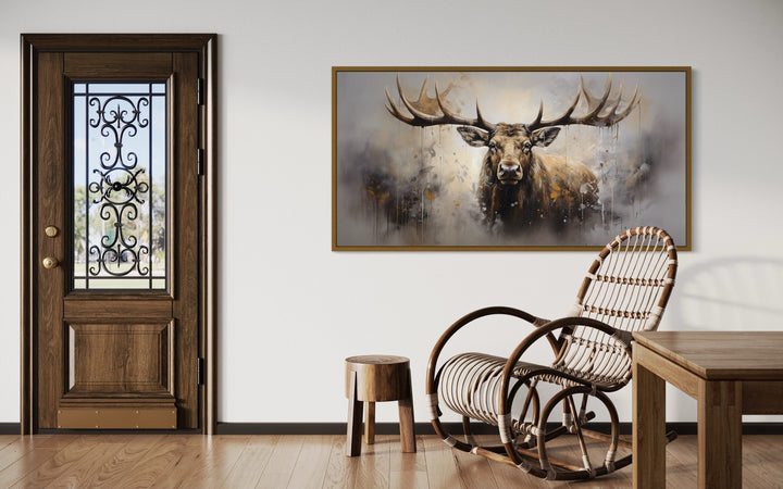 Extra large framed abstract moose canvas print in a rustic room with a rocking chair and wood door.