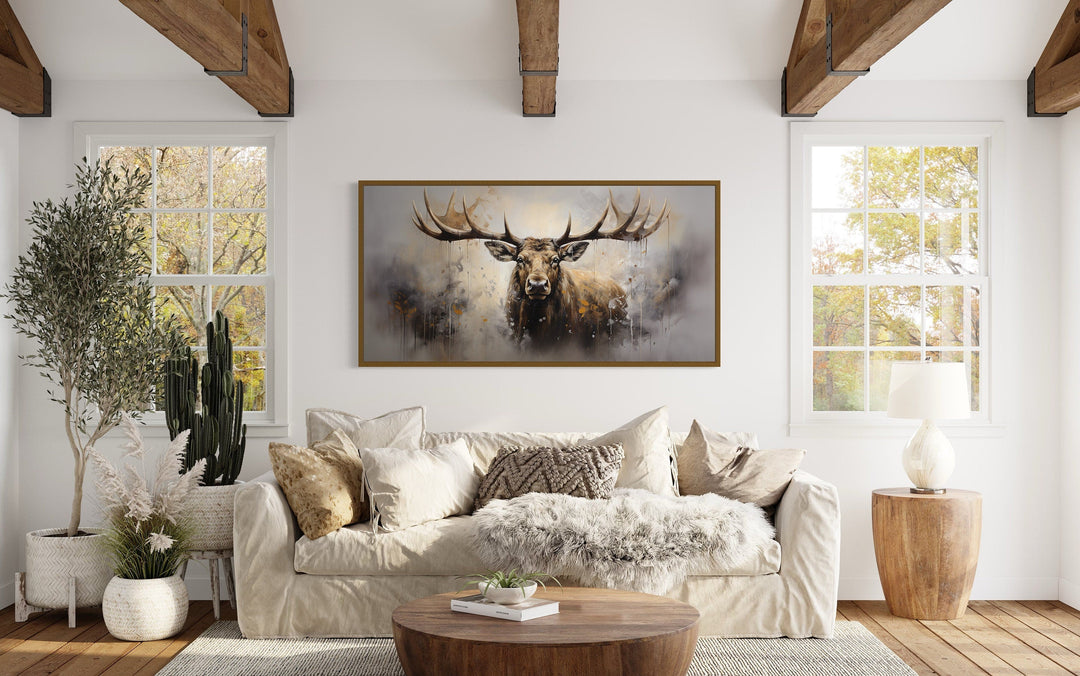 Extra large framed abstract moose canvas print in a rustic living room with a neutral sofa.