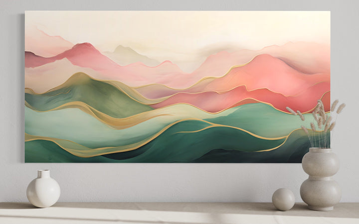 Abstract mountain wall art on framed canvas with a soft blush pink and green color palette.