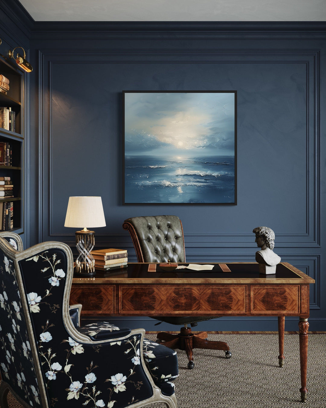 Abstract ocean framed canvas wall art with blue and grey waves hanging in a dark blue home office.