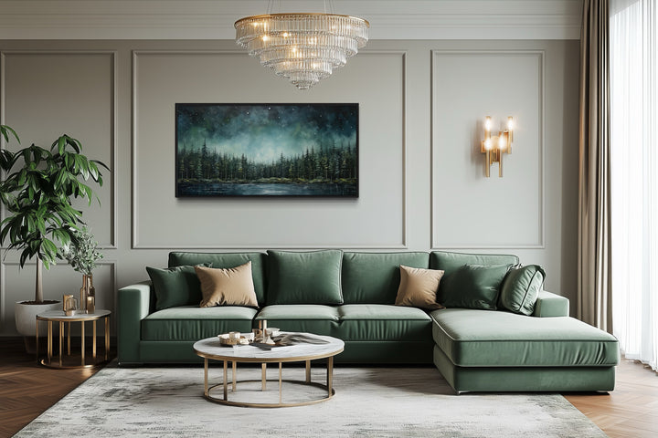 Abstract starry sky wall art featuring a green fir forest and tranquil lake above a green sofa.