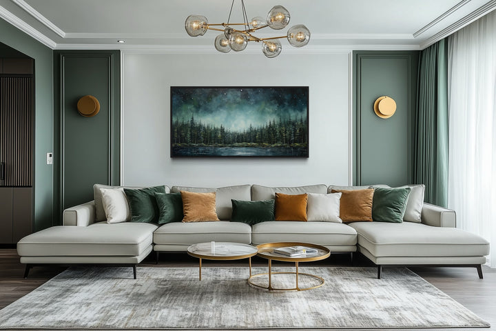 Abstract starry sky over a green fir forest and tranquil lake canvas art above a modern sofa.