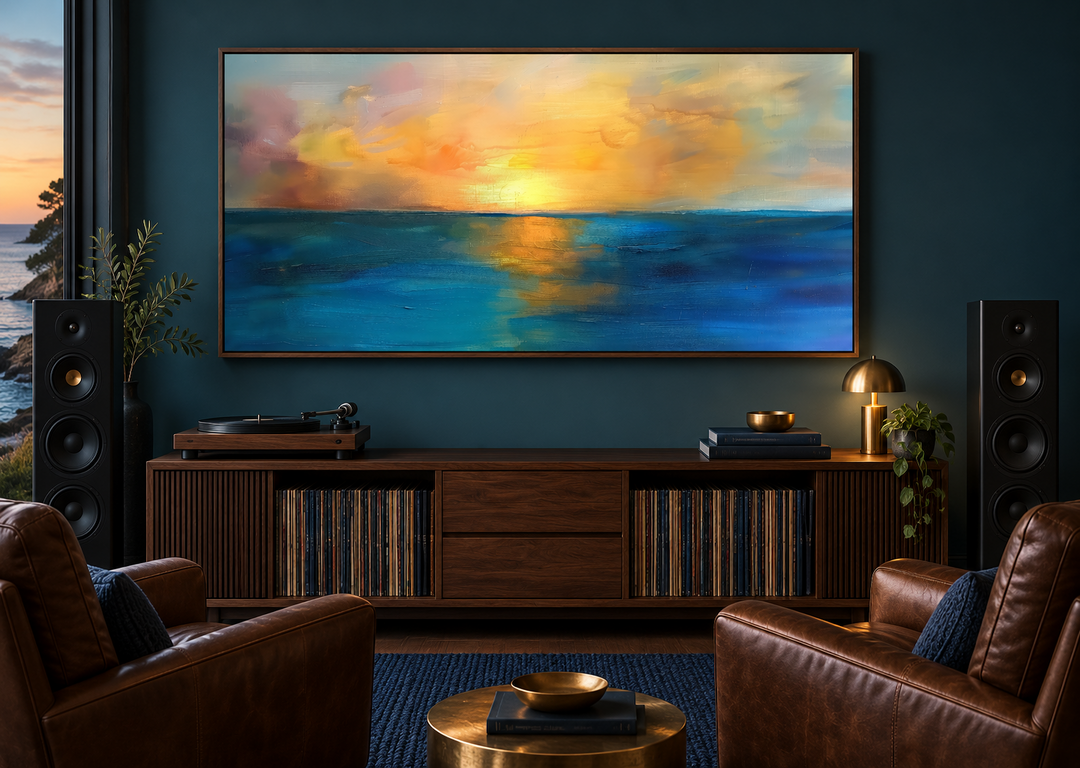Extra large framed canvas of an abstract ocean sunset in navy and gold above a wooden console.