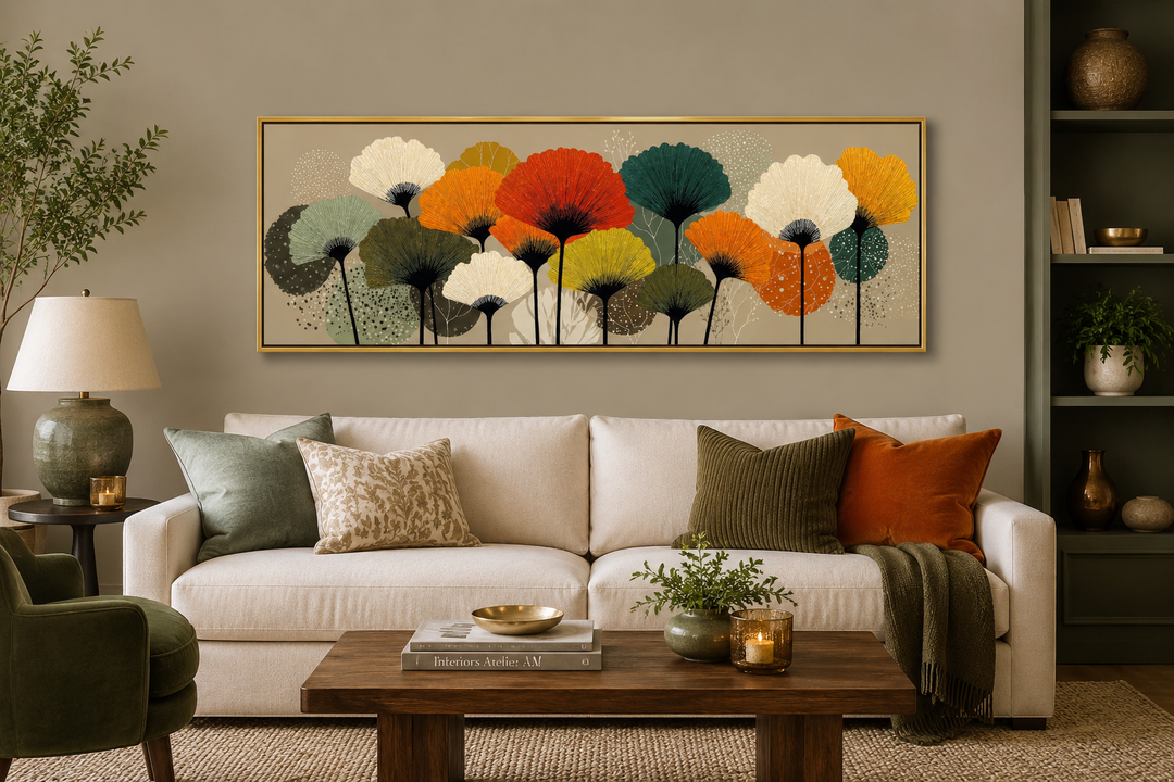 Long horizontal abstract botanical canvas art with orange and olive green floral forms over a sofa.