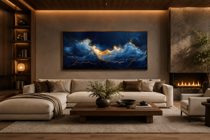 Navy blue and gold abstract ocean wave canvas wall art hanging above a modern sofa in a living room.