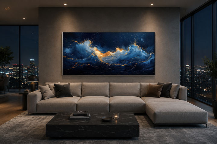 Abstract navy blue and gold ocean wave canvas wall art hanging above a modern sofa in a living room.