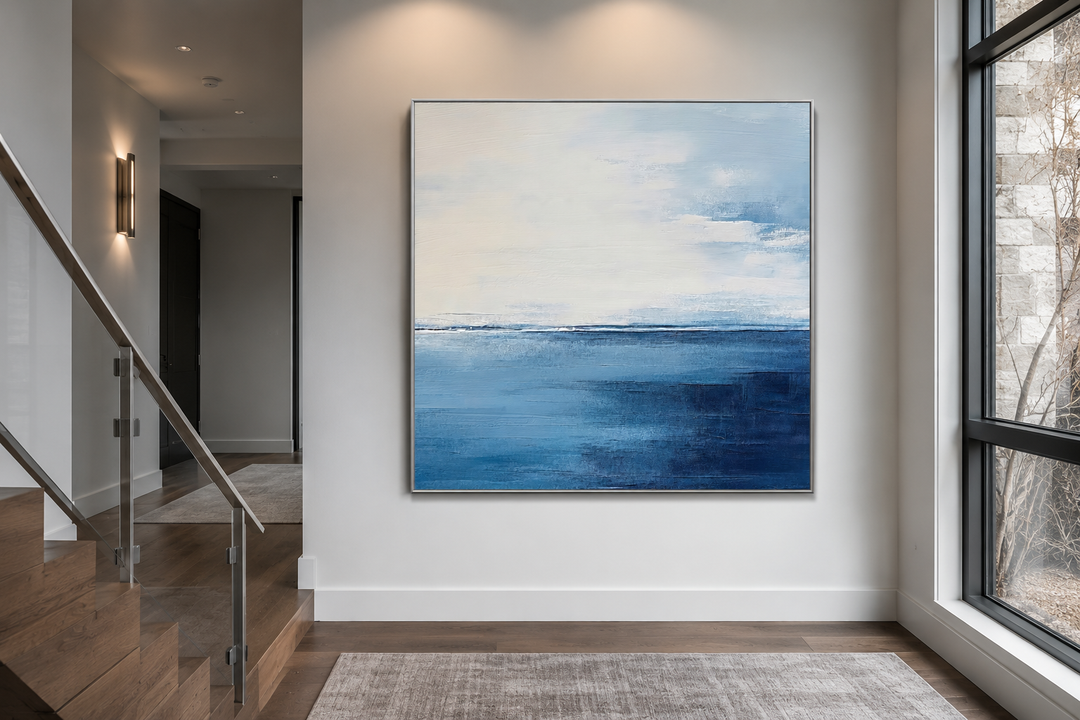 Abstract square framed canvas wall art featuring a navy blue, grey, and silver ocean horizon.