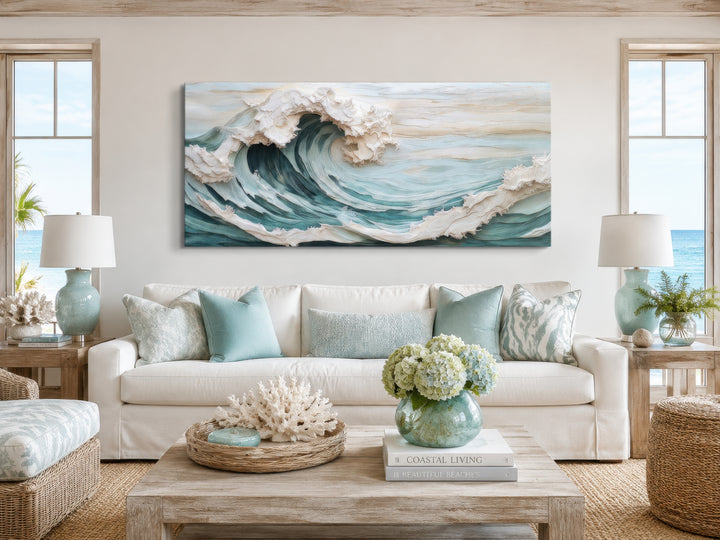 Abstract 3D effect teal ocean wave framed canvas wall art hanging above a white sofa.