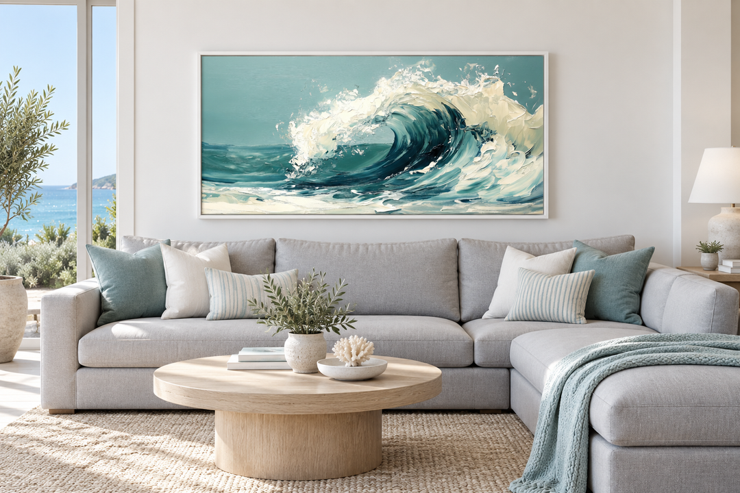 Abstract teal ocean wave framed canvas wall art hanging above a grey sectional sofa.