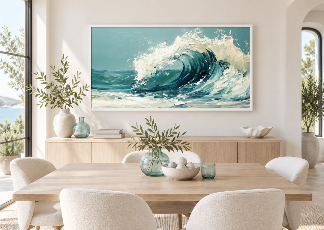 Abstract teal ocean wave framed canvas wall art hanging above a wooden dining table in a bright room.
