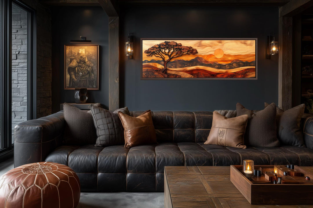 Acacia tree wall art in a wood carving style on a long narrow canvas above a dark leather sofa.