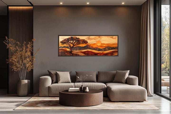 Acacia tree wall art in a wood carving style on a long narrow canvas above a modern sofa.