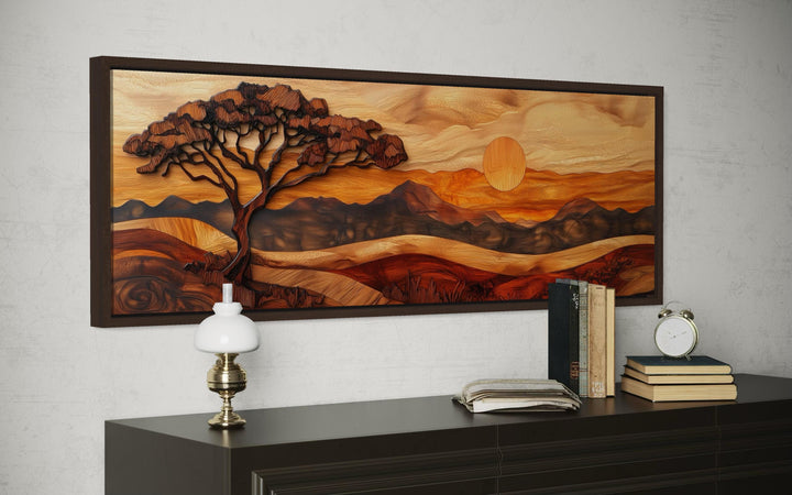 Horizontal canvas wall art of an acacia tree and savanna sunset in a textured wood carving style.
