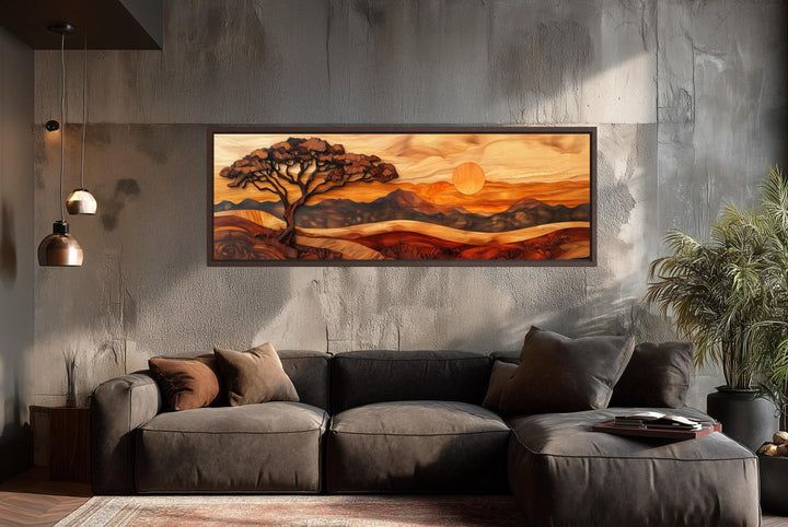 Acacia tree wall art in a wood carving style on a long narrow canvas above a modern sofa.