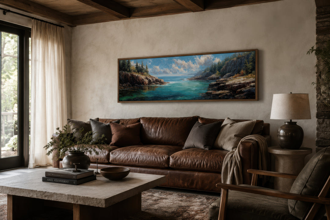 Panoramic Acadia National Park canvas wall art above a brown leather sofa in a rustic living room.