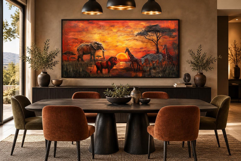 African animals in savannah at sunset framed canvas wall art above a dining table.
