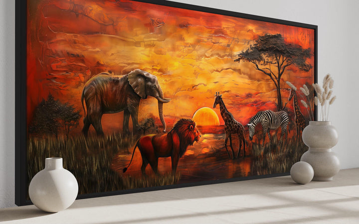 African animals in savannah at sunset framed canvas wall art with elephant, lion, and giraffe.