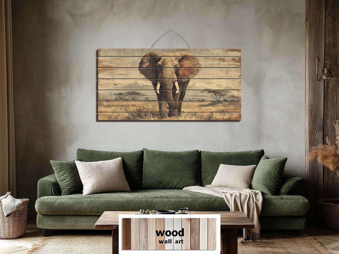 African elephant wall art on distressed wood planks hanging above a green sofa in a rustic room.