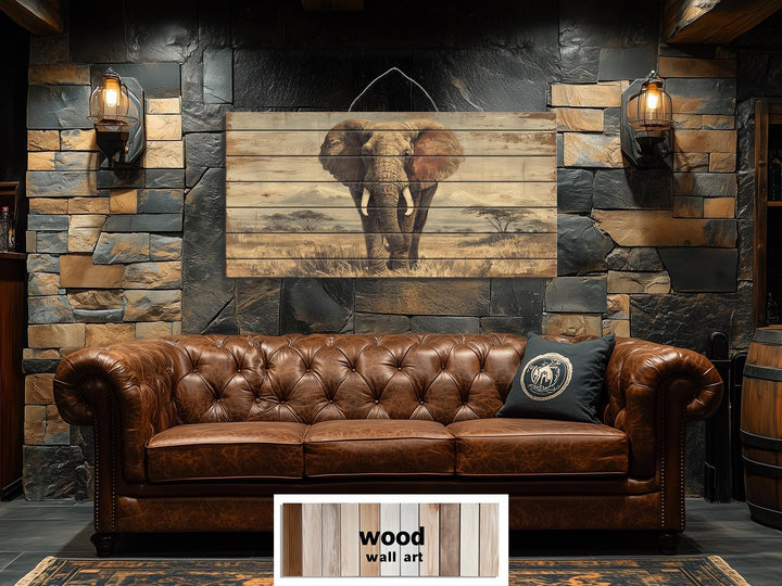 African elephant wall art on distressed wood planks above a brown leather sofa in a rustic room.
