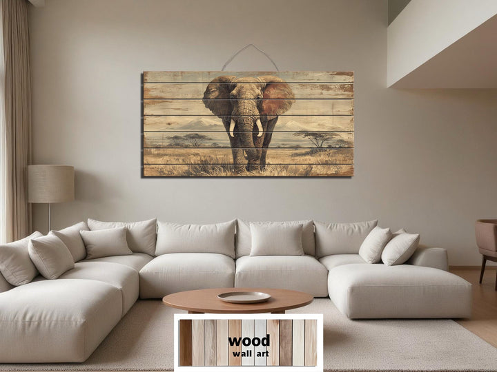 African elephant wall art on distressed wood planks hanging above a modern sectional sofa.