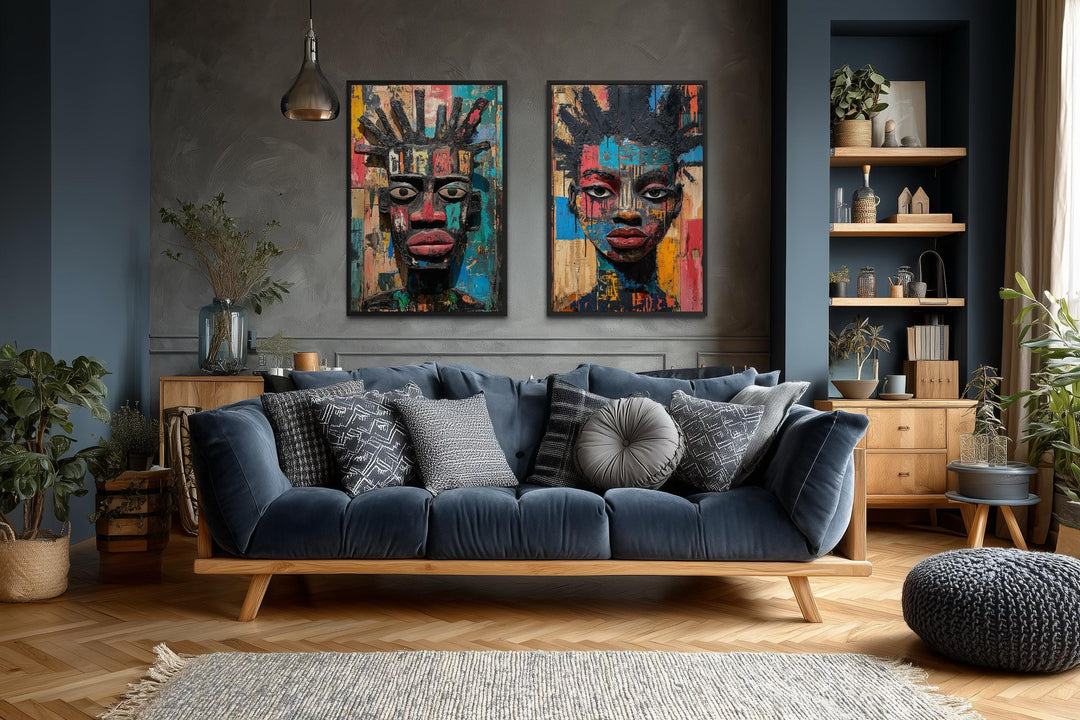 Set of two colorful African mask canvas prints featuring abstract tribal faces in a modern room.