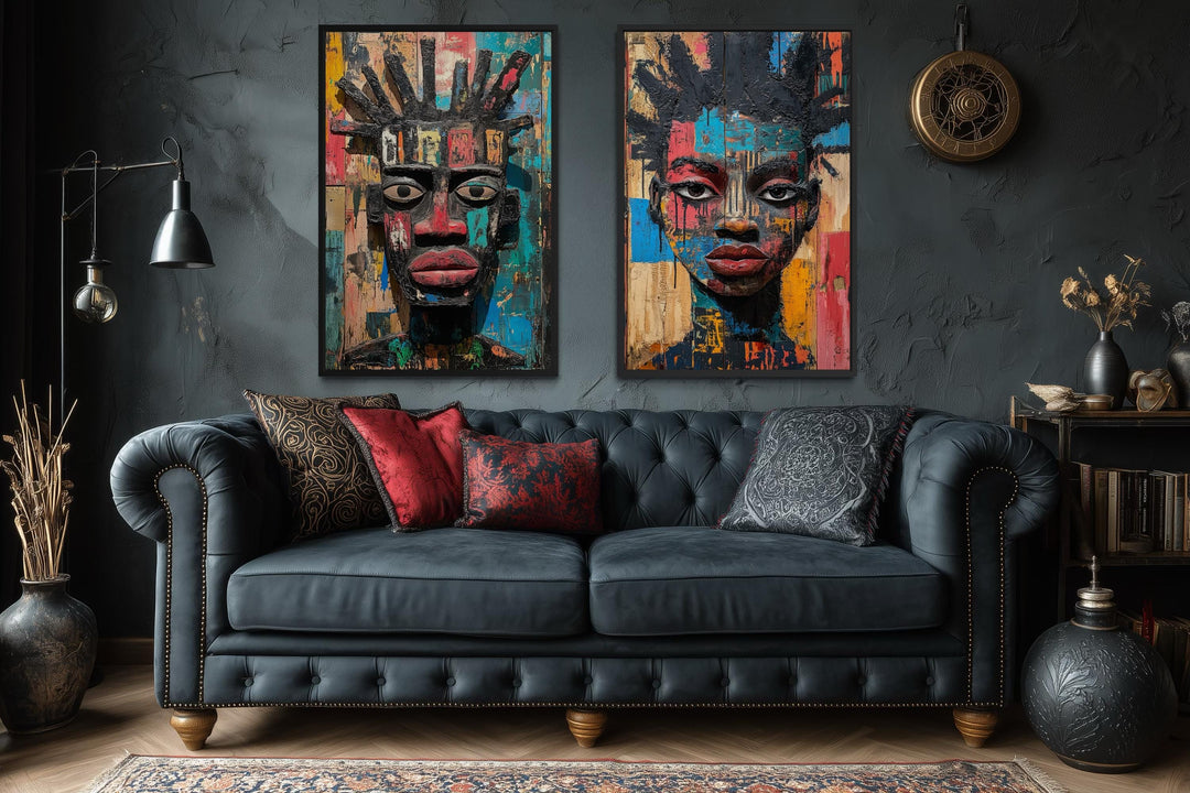 Set of two colorful African mask canvas prints featuring abstract tribal faces on a dark wall.