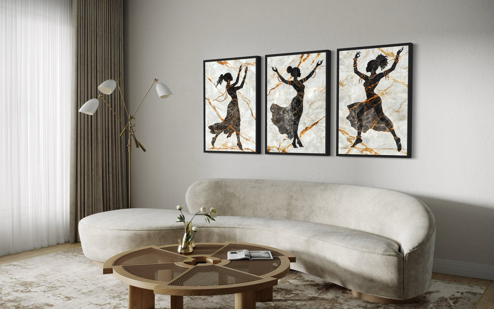 Three-piece framed canvas wall art featuring black silhouettes of African dancers with gold accents.