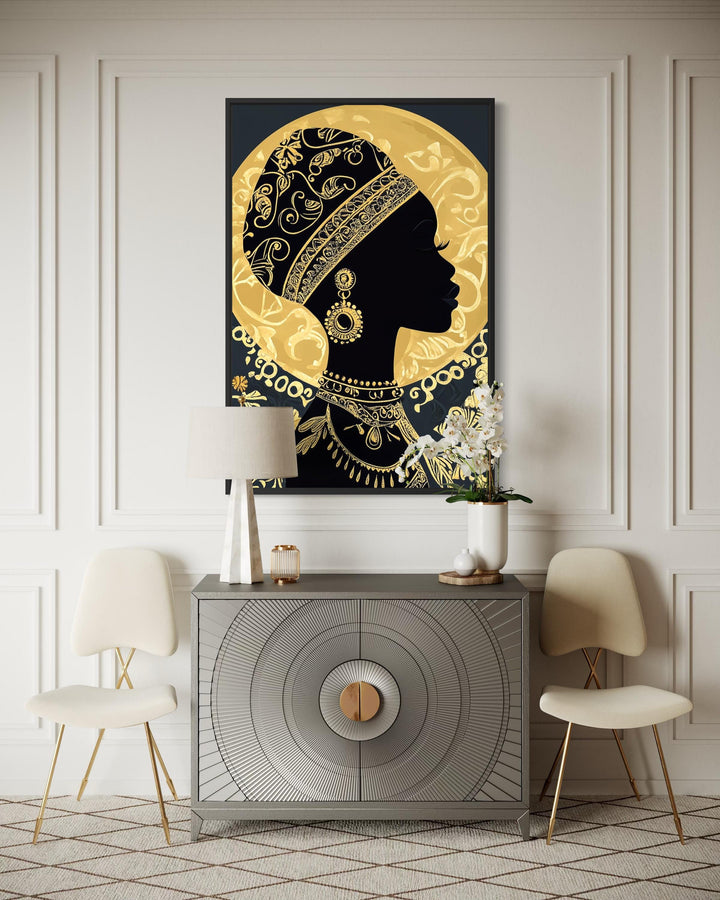 A black and gold canvas print of an African woman in profile, styled in an elegant modern room.