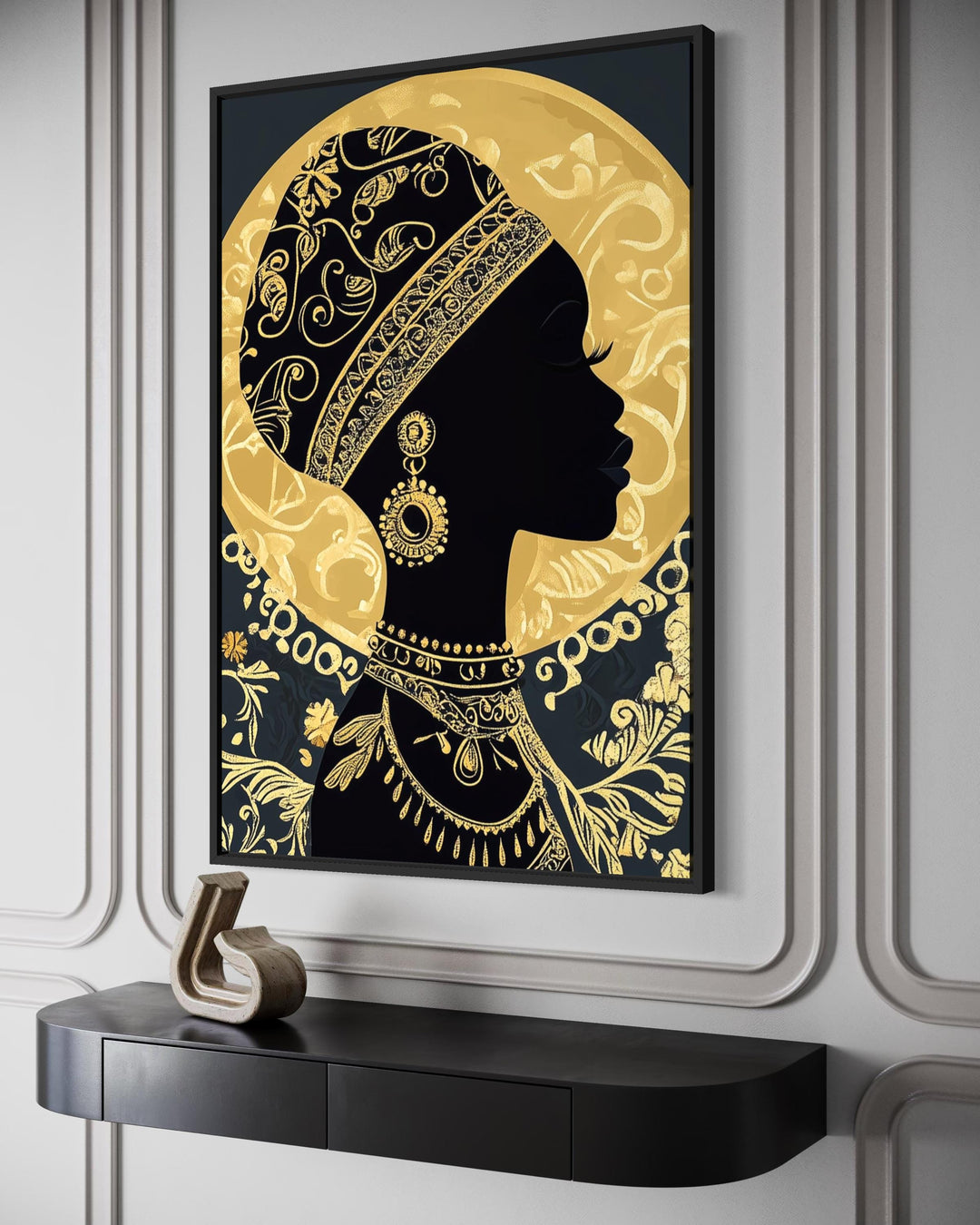 A black and gold canvas print of an African woman in profile hangs above a modern console table.