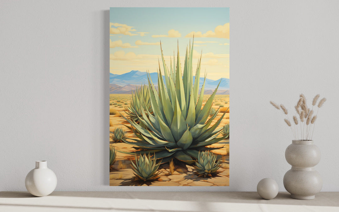 Agave in the desert framed canvas wall art displayed above a shelf with decorative vases.