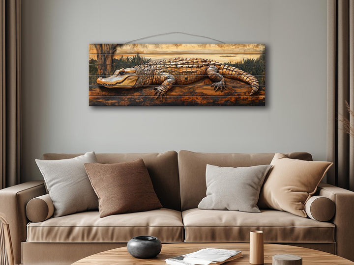 Rustic alligator wall art printed on horizontal wood planks hanging above a modern tan sofa.