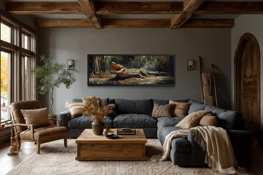 A long horizontal canvas print of an alligator in a swamp hangs in a rustic, modern living room.