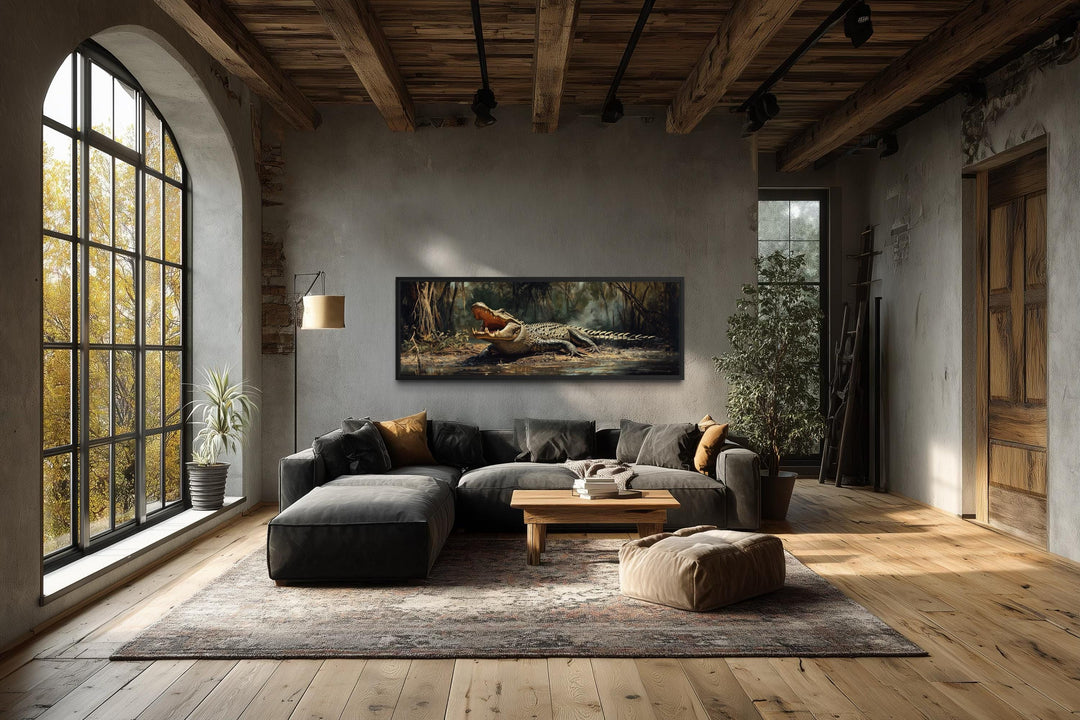 A long horizontal canvas print of an alligator in a swamp hangs above a sofa in a rustic living room.