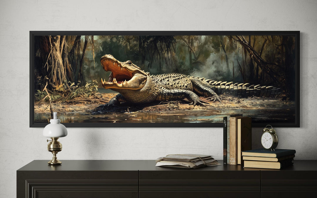 Horizontal canvas print of an alligator in a swamp, framed and displayed above a dark wood dresser.