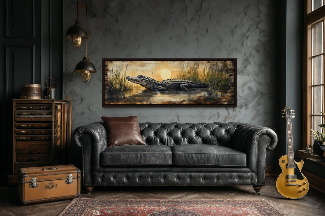Alligator in marshland sunset horizontal wall art with a dark leather sofa.