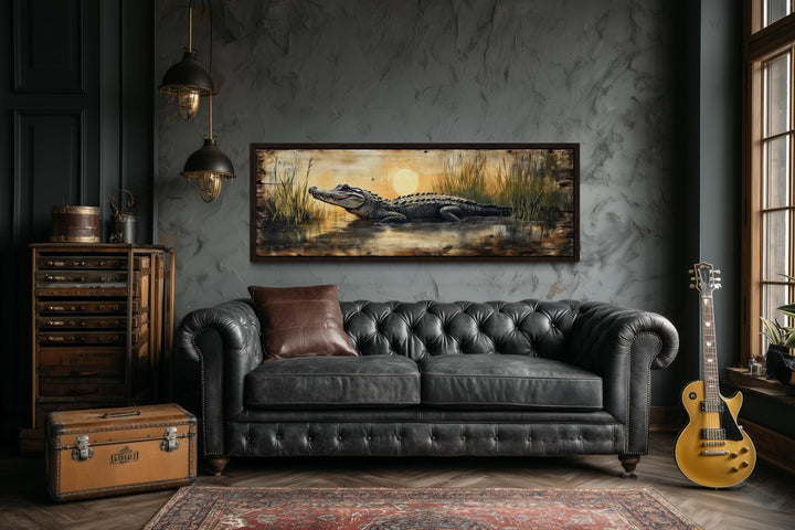 Alligator in marshland sunset horizontal wall art with a dark leather sofa.