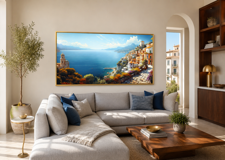 Large framed canvas print of an Amalfi Coast painting above a modern grey sectional sofa.