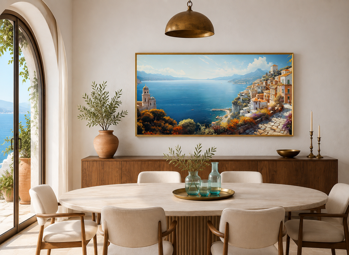 Large framed Amalfi Coast canvas painting of an Italian coastal town above a dining room sideboard.