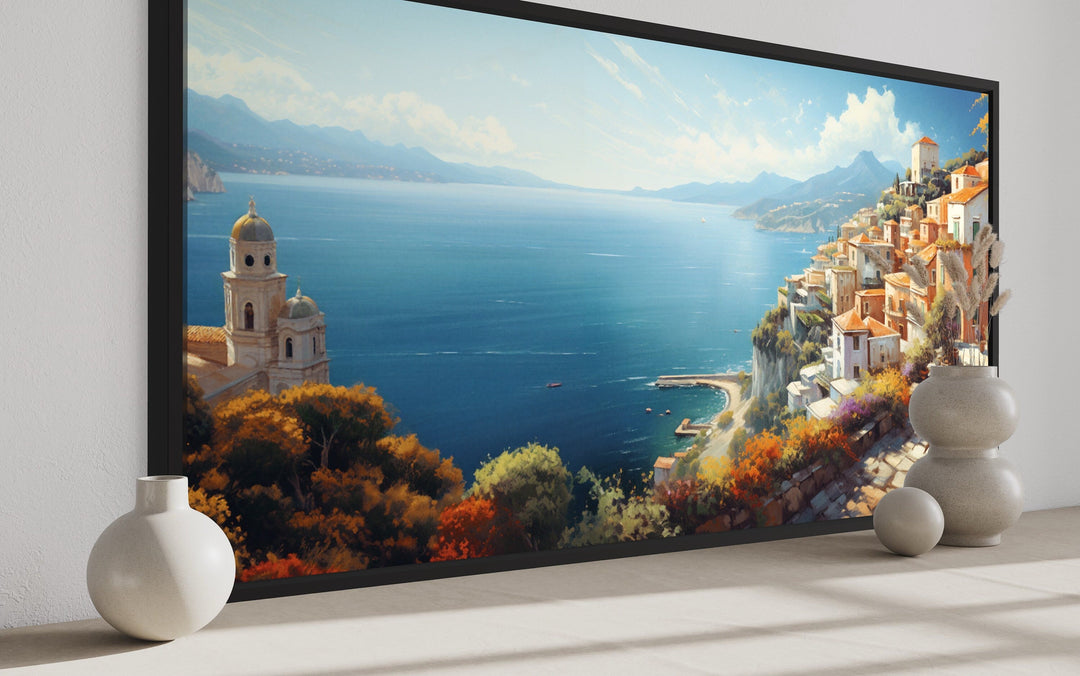 Amalfi Coast wall art featuring a large Italian coastal painting in a black frame on a white wall.